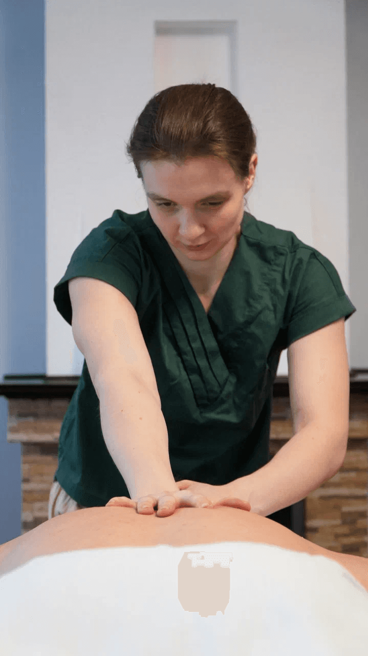 a woman getting a back massage at a spa